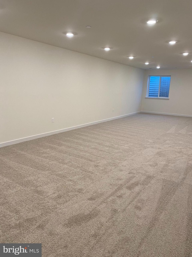 carpeted empty room featuring recessed lighting and baseboards