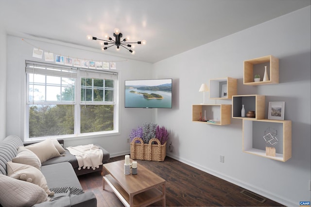 living room featuring an inviting chandelier, baseboards, visible vents, and dark wood finished floors