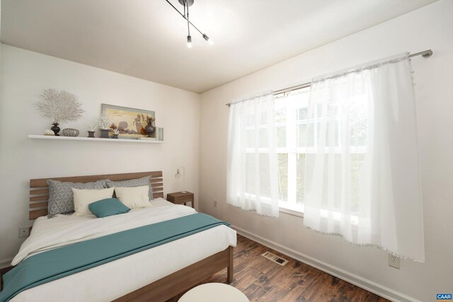 bedroom with dark wood-type flooring