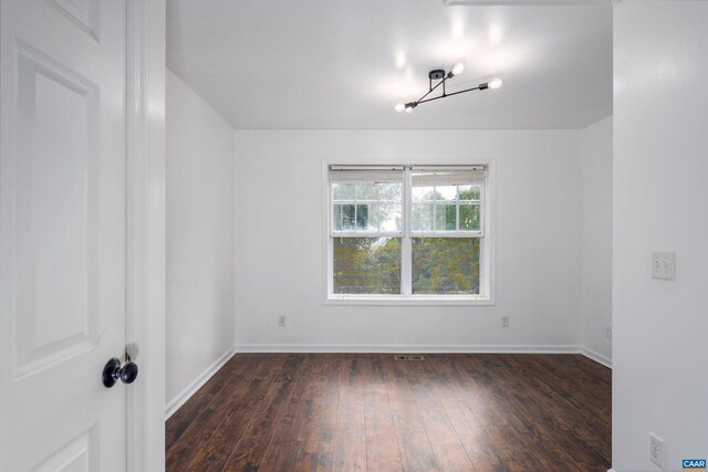 spare room featuring dark hardwood / wood-style floors