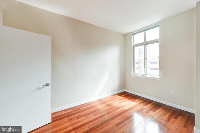 unfurnished room with hardwood / wood-style floors