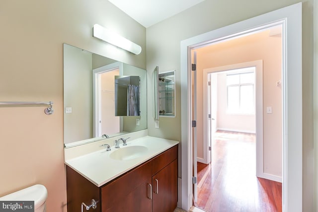 bathroom featuring vanity, toilet, and wood-type flooring