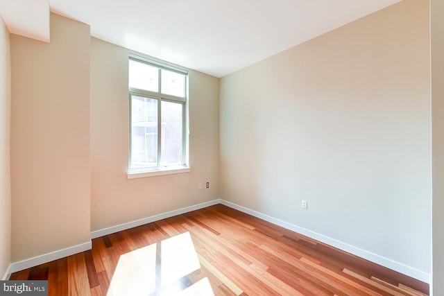 unfurnished room with hardwood / wood-style floors