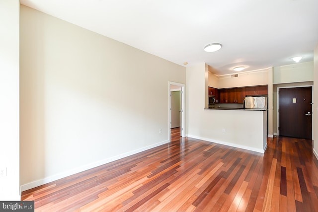 unfurnished living room with dark hardwood / wood-style flooring