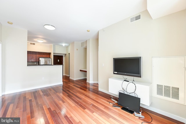 unfurnished living room with hardwood / wood-style floors