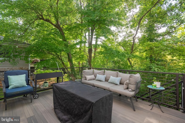 wooden terrace with an outdoor hangout area