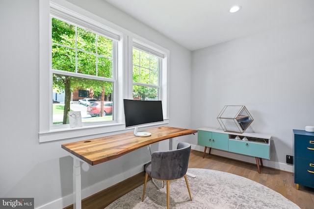 office space featuring baseboards, wood finished floors, and recessed lighting