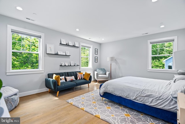 bedroom with light wood-type flooring, visible vents, baseboards, and recessed lighting