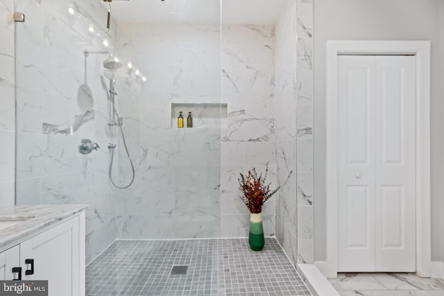 full bath with a closet, vanity, a marble finish shower, and marble finish floor