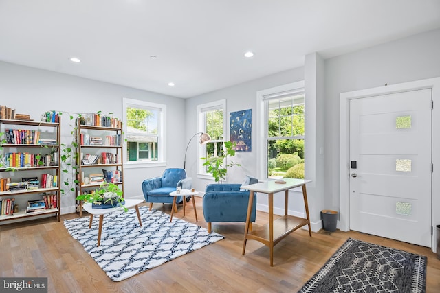 living area featuring recessed lighting, baseboards, and wood finished floors