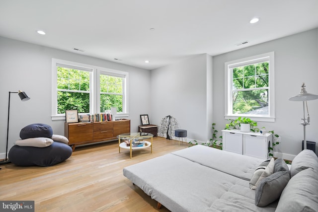 bedroom with baseboards, light wood-type flooring, visible vents, and recessed lighting