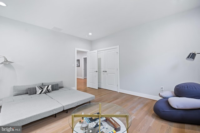 interior space featuring baseboards, wood finished floors, and recessed lighting