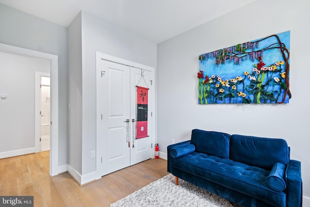 living area featuring baseboards and wood finished floors