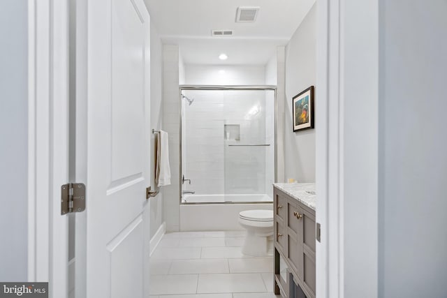 full bath featuring visible vents, toilet, shower / bath combination with glass door, tile patterned floors, and vanity