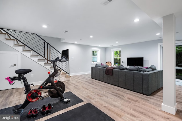 workout area with baseboards, recessed lighting, visible vents, and light wood-style floors