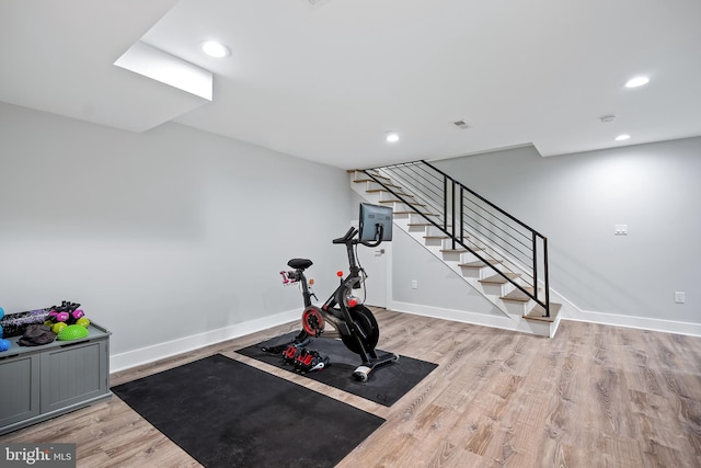 workout room with light wood-style floors, baseboards, and recessed lighting