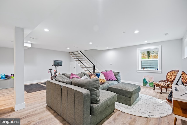 living area with visible vents, stairway, light wood-style flooring, and recessed lighting