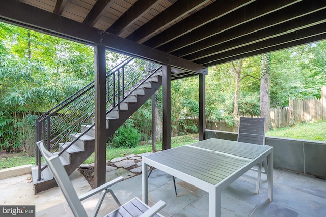 view of patio / terrace with fence, stairway, and outdoor dining space