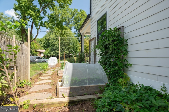 exterior space with a garden and fence