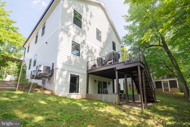 back of house with a wooden deck, stairs, and a yard