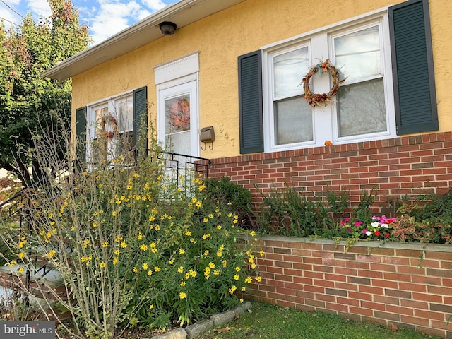 view of home's exterior with brick siding and stucco siding