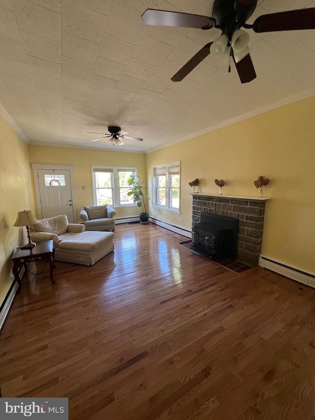 unfurnished living room with a fireplace, baseboard heating, ceiling fan, and dark wood-type flooring