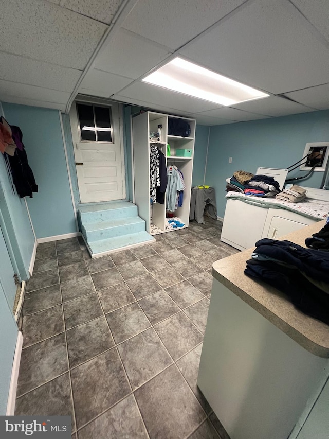 interior space featuring dark tile patterned flooring and baseboards