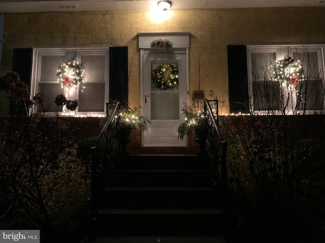 view of exterior entry at night