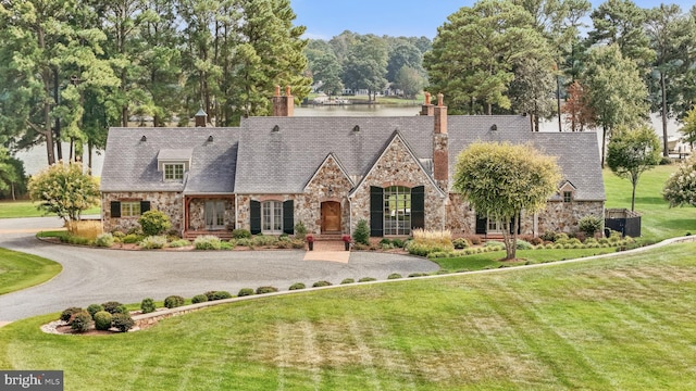 tudor house featuring a front lawn