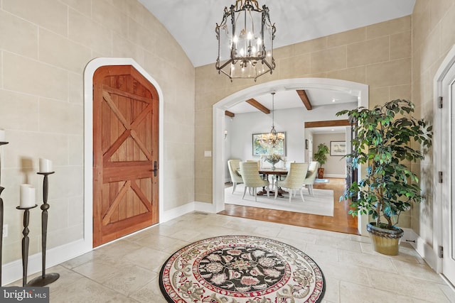 entrance foyer featuring tile walls and a notable chandelier