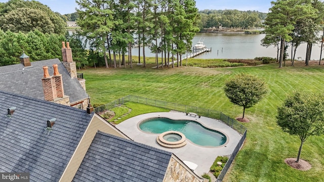 exterior space with an in ground hot tub and a water view