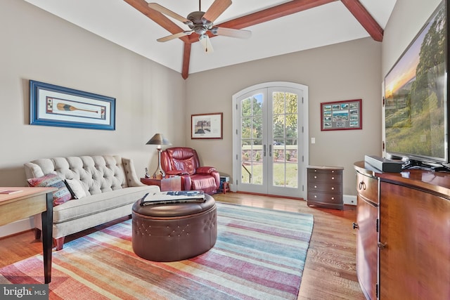 living room with light hardwood / wood-style flooring, ceiling fan, lofted ceiling with beams, and french doors