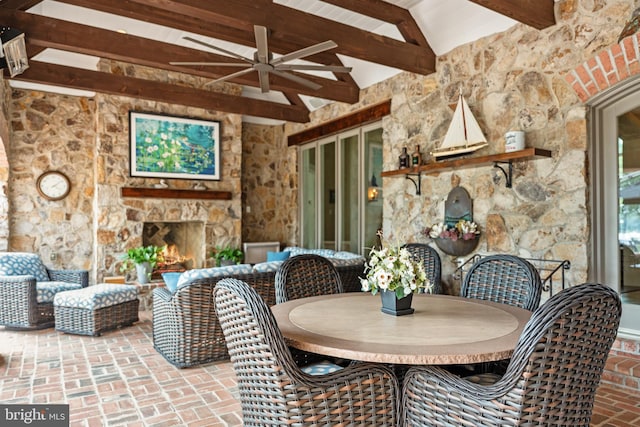 view of patio / terrace featuring an outdoor living space with a fireplace and ceiling fan