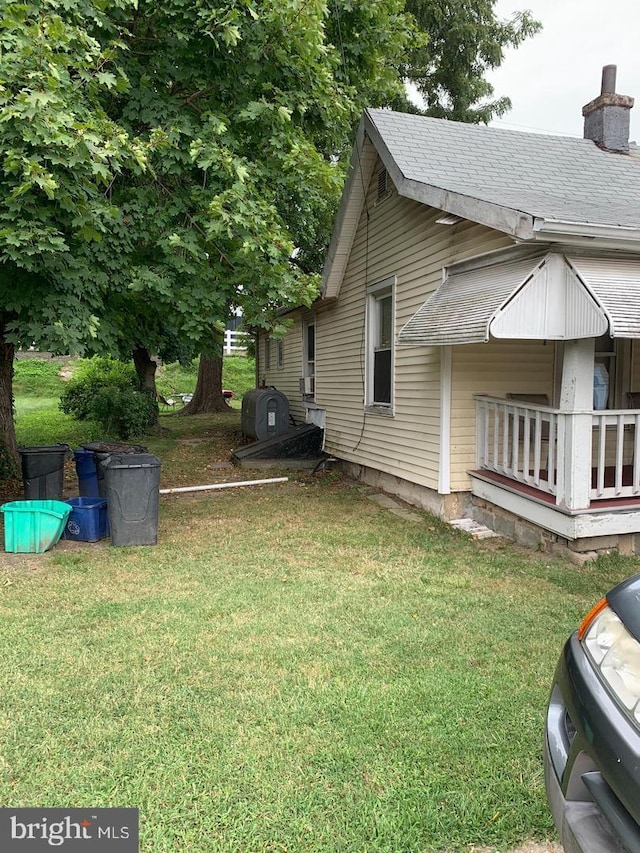 view of property exterior featuring a lawn