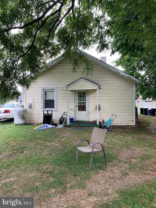 back of property featuring a yard