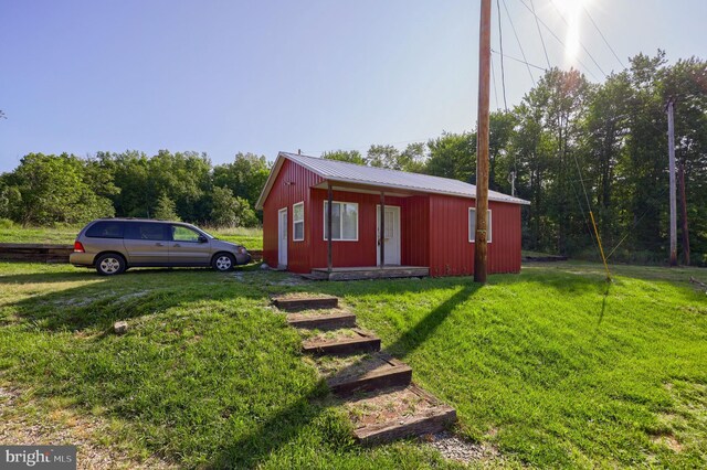 view of outbuilding with a yard