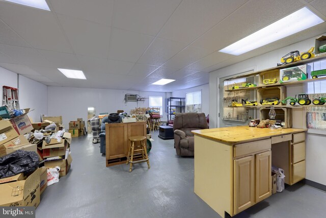 kitchen featuring concrete floors and a drop ceiling