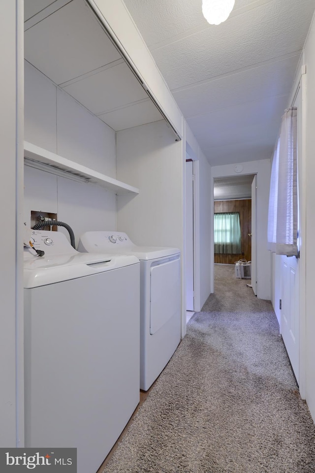 washroom featuring light colored carpet and separate washer and dryer