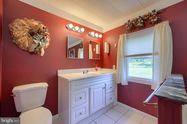 bathroom featuring tile patterned floors, toilet, and vanity