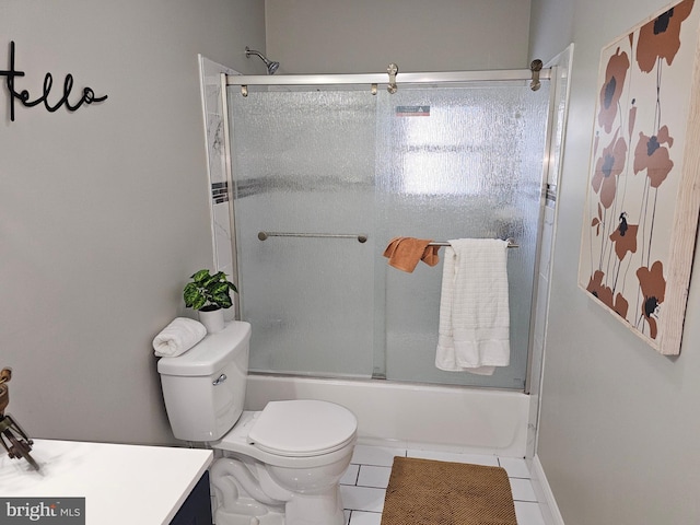 bathroom with enclosed tub / shower combo, vanity, tile patterned flooring, and toilet