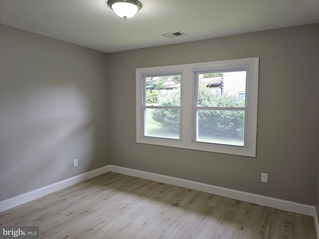 spare room featuring light hardwood / wood-style flooring