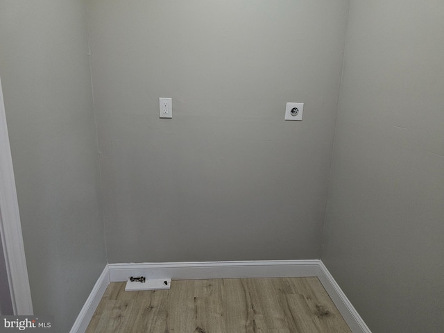 laundry room with hookup for an electric dryer and wood-type flooring