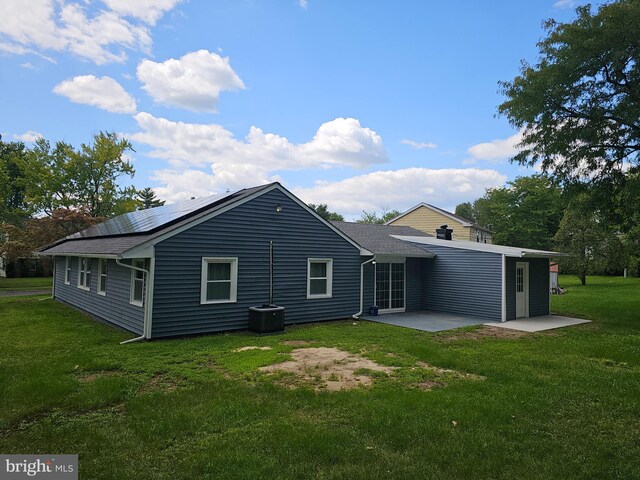 rear view of property featuring a patio area and a yard