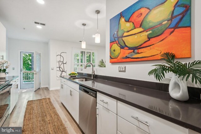 kitchen featuring plenty of natural light, stainless steel appliances, light hardwood / wood-style flooring, and white cabinets