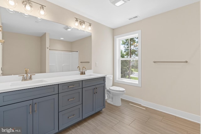 bathroom with tile patterned floors, a shower with shower curtain, vanity, and toilet