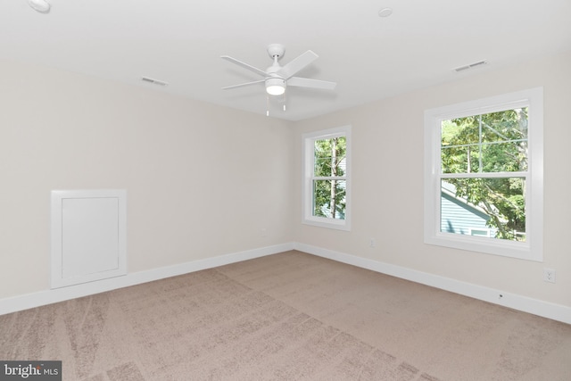 carpeted empty room featuring ceiling fan