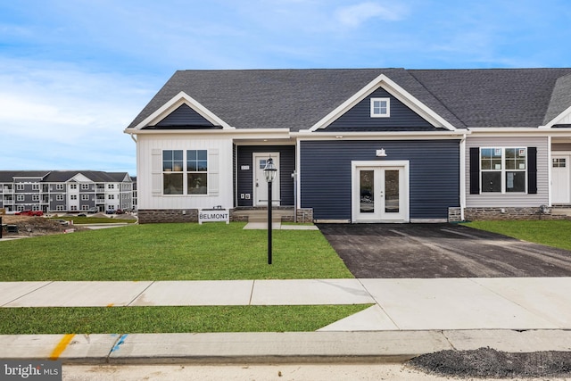 view of front of property with a front yard and french doors