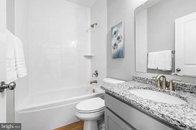 full bath featuring toilet, vanity, bathtub / shower combination, and wood finished floors