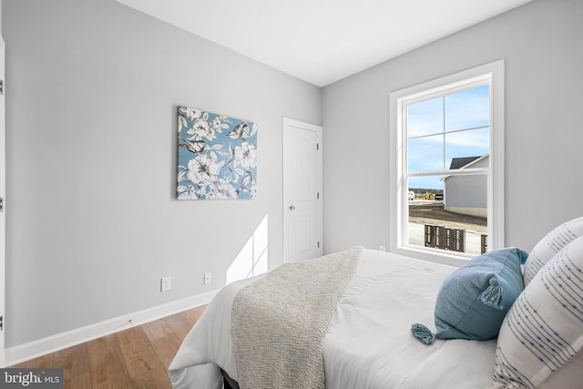 bedroom featuring baseboards and wood finished floors