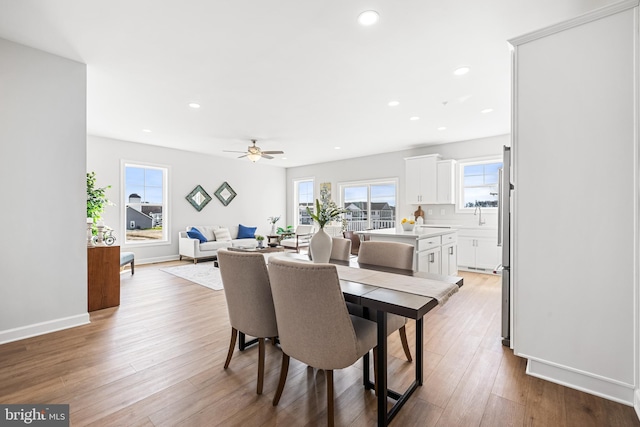 dining area with recessed lighting, light wood-type flooring, baseboards, and ceiling fan